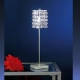 La lámpara de mesa Pyton es un velador fabricado en metal, de una luz y con decoración de cristal. El mismo está disponible en color cromo.