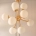 Colgante Nébula. Luminaria de estructura metálica, estilo moderno y 12 luces. Opcional con o sin tulipas. Disponible en negro, cobre, bronce o plátil.
