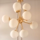 Colgante Nébula. Luminaria de estructura metálica, estilo moderno y 12 luces. Opcional con o sin tulipas. Disponible en negro, cobre, bronce o plátil.